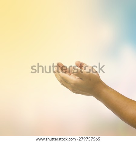 open hand on blurred abstract nature background - concept help