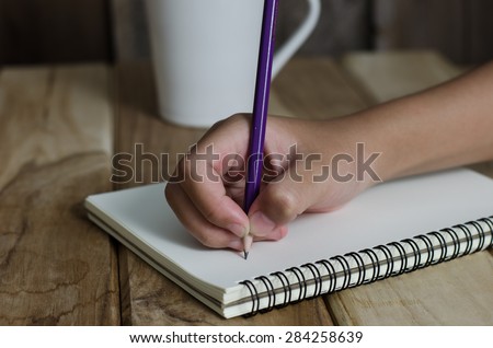 Hand drawing in open notebook on table