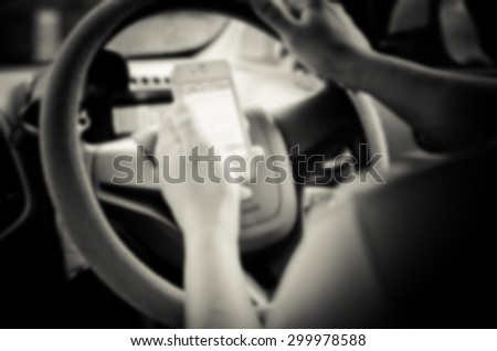 Blur images of people using smartphones while driving, safety driving.