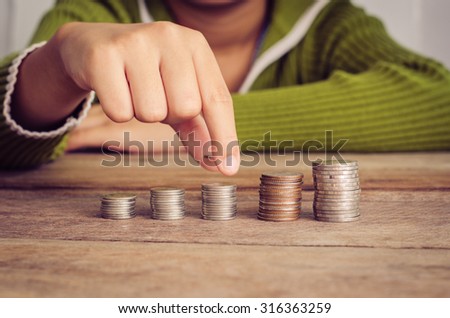 hand putting money coin on each line rising - business saving money concept.