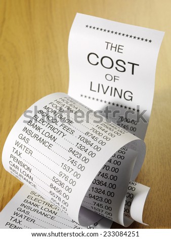 Cost of living expense list showing the prices of running a home on a wooden background