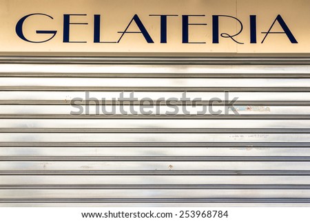 An old Italian ice cream shop with the lowered shutter.