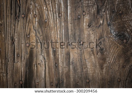 Horizontal background of raw wood with rusty nails.