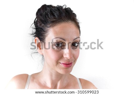 Close up of the face of a young woman with light skin and natural tones.