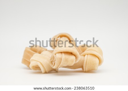 Close up of artificial bone treat for dog and healthy oral hygiene on white background