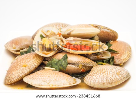 Close up of stir fried surf clams with basil leaf for spicy taste and food on white background