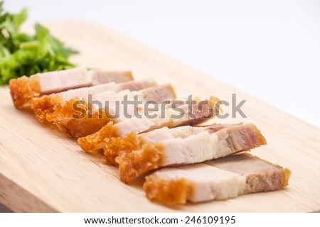 Delicious and crispy deep fried pork belly on cutting board for food on white background