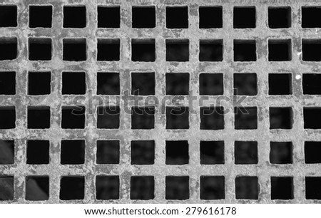 Black and white square rustic metal plate on the ground for construction barrier
