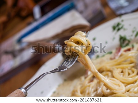 Close up of fork picking up Italian spaghetti for exotic food background