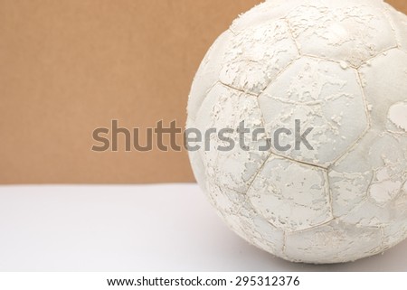 Close up of aged or torn football or soccer ball for sport background