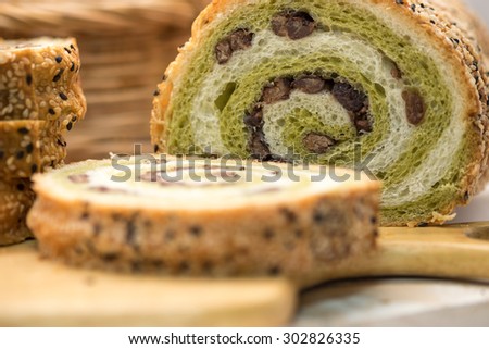 Fresh whole grain red bean and green tea bread and loaf on wood cutting board for healthy diet background