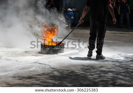 Man demonstrating fire drill exercise with white smoke for disaster protection background