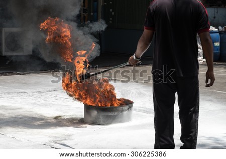 Man demonstrating fire drill exercise with white smoke for disaster protection background