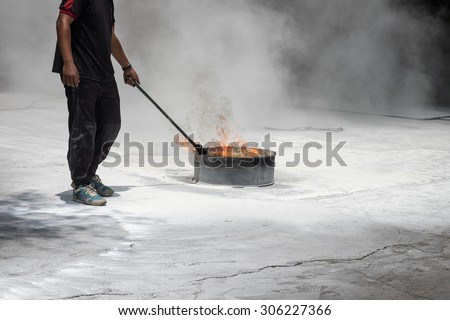 A man igniting fire for fire drill exercise for safety and protection background