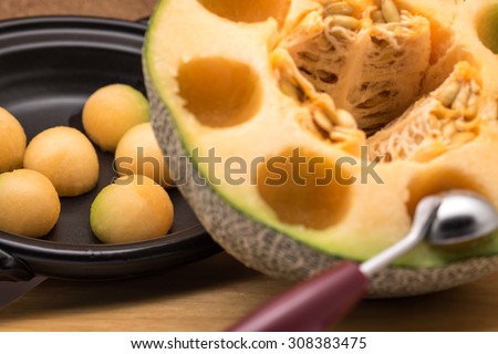 Fresh and ripe orange melon or cantaloupe fruit carved in balls with selective focused point