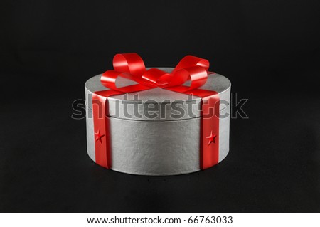 Silver gift box with red ribbon - black background