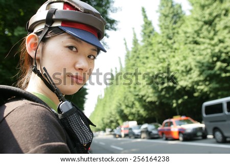 Portrait of a young woman wearing a cycling helmet