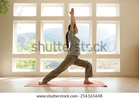 Side profile of a young woman practicing yoga