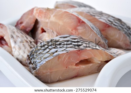 portion cut of fresh Tilapia fish on plate