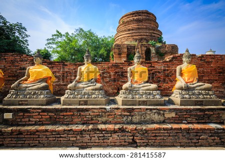 buddhist statues in sitting position with clear blue sky background