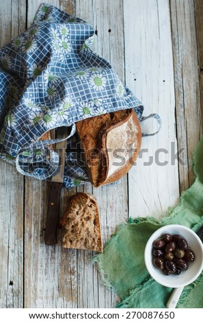 Fresh grain bread with olive over rustic white table. Rustic style. Top view.