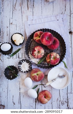 Ingredients to prepare homemade pie, muffins,cupcakes with nectarines from above. Rustic style.