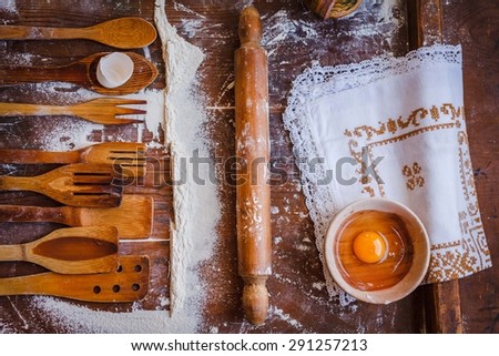 Creative retro food design. A philosophy homemade and retro food. Rustic kitchen wooden utensils with rustic embroidery linen and eggs shells from above.