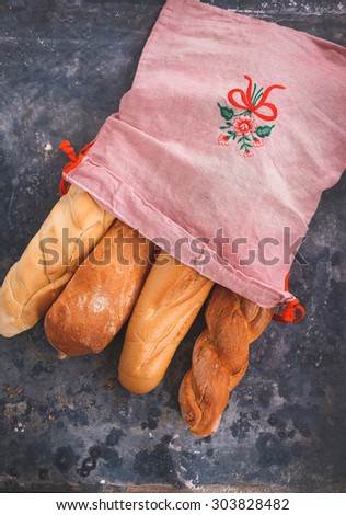 Various freshly baked french Baguettes over on a rustic blue background. Four different baguettes para sandwich from above.Country style