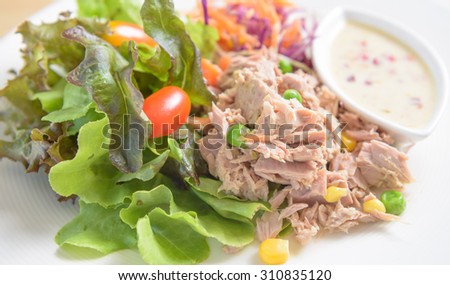 salad tuna with maize corn and pea carrot vegetable on white dish