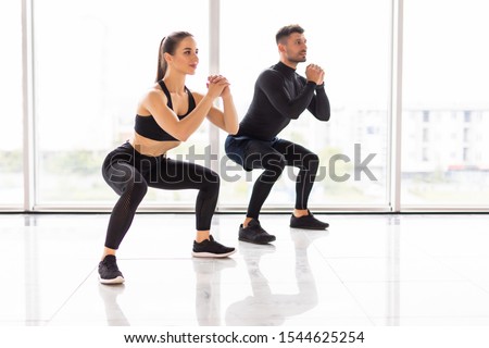 Similar – Image, Stock Photo Confident man exercising on cycling machine in gym