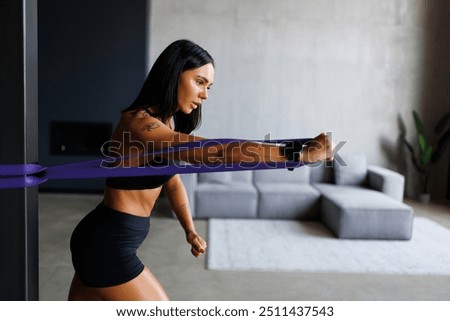 Similar – Image, Stock Photo Woman with resistance band on wrists working out at home