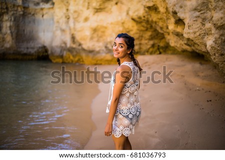 https://image.shutterstock.com/display_pic_with_logo/2660524/681036793/stock-photo-beutiful-latin-mexican-girl-tourist-walking-on-beach-with-rocks-on-beautiful-beach-near-ocean-681036793.jpg