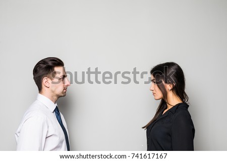 Concept of confrontation in business. Close up photo of two young serious confident people standing face-to-face to each other ストックフォト © 