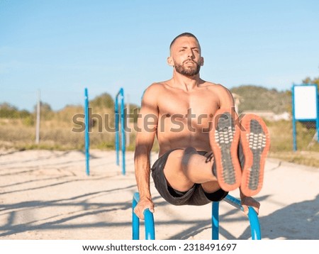 Image, Stock Photo Young sportsman performing L sit on street railing