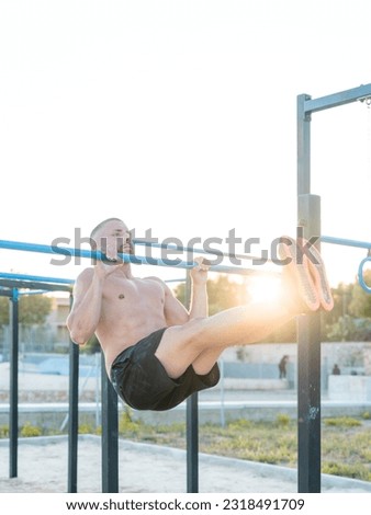 Similar – Image, Stock Photo Young sportsman performing L sit on street railing