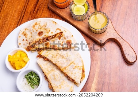 Shepherd's meat tacos with corn tortillas. Gringa with cheese. Mexican food on wooden background. Mexican gringa with hot sauce. Mexican taco concept. Mexican food concept.