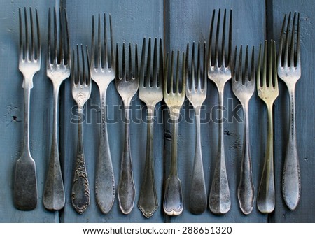 Vintage forks on blue, wooden table