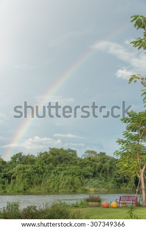 very beautiful rainbow cross on clear blue sky