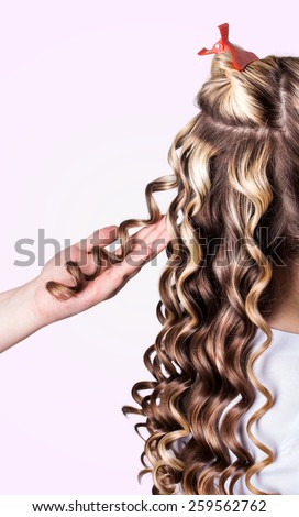 Beauty girl with blonde curly hair. Healthy and long Blond Wavy hair.