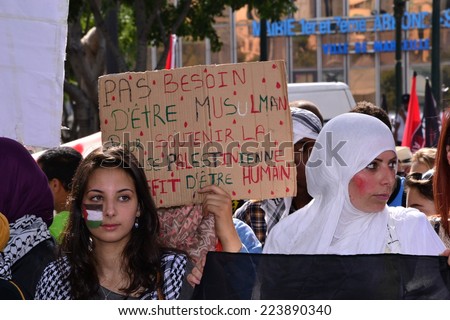 Marseille, France - August 9, 2014: Woman hold a sign reading No need to be a muslim to support Palestinian people as people take part in a demonstration against Israel\'s military operations in Gaza.