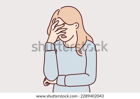 Upset girl covers face with hand due to stress and lack of strength to solve problems. Woman doing facepalm gesture feeling stressed and depressed or frustrated after another failure 