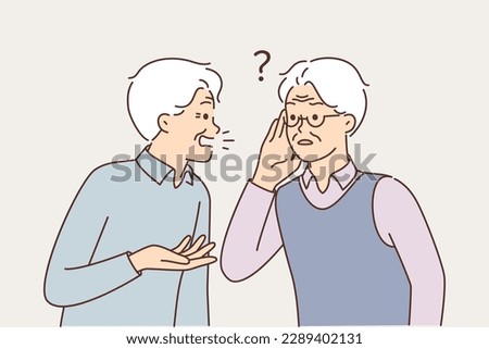 Old man talking to deaf friend who puts hand to ear and is having problems after hearing aid is broken. Elderly gray-haired man suffering from hearing disease needs help of otolaryngologist doctor 
