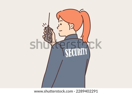 Woman security guard uses walkie-talkie to contact colleagues or report intruder. Girl in uniform with inscription security on back monitors observance of order at stadium or in supermarket