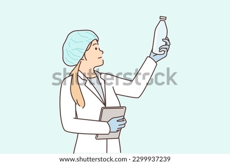 Woman laboratory assistant with glass bottle checks chemical composition of milk produced in factory. Professional girl performs quality control working as technologist at food factory.