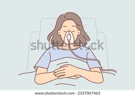 Woman patient of clinic with oxygen mask on face lies in hospital room connected to ventilator. Young girl patient is unconscious after accident in need of surgery or organ transplant