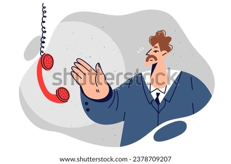 Business man near telephone receiver hanging on wire is waiting for call from partner or colleague. Businessman in formal clothes reaches hand to phone wanting to make business call.
