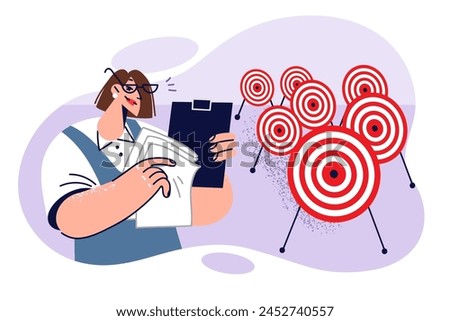 Business woman is engaged in setting goals and objectives or planning, standing near many darts targets. Girl business manager holds clipboard with papers, tracking performance of subordinates