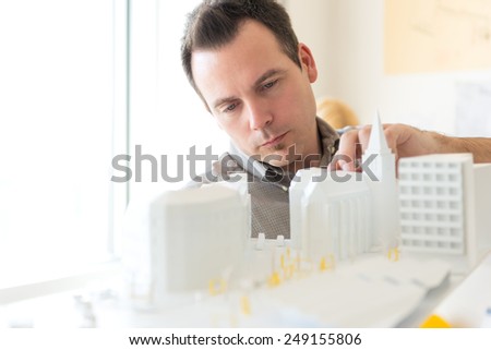 Young architect working on a new architectural model