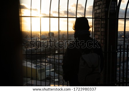 2018, a Woman stands at Panoramapunkt Berlin Potsdamer Platz. She is Looking above Berlin. 
We´ve got a Sneak piek of Berlin while sunset Zdjęcia stock © 