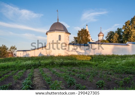 Potato beds against walls of the Christian monastery in sunset light